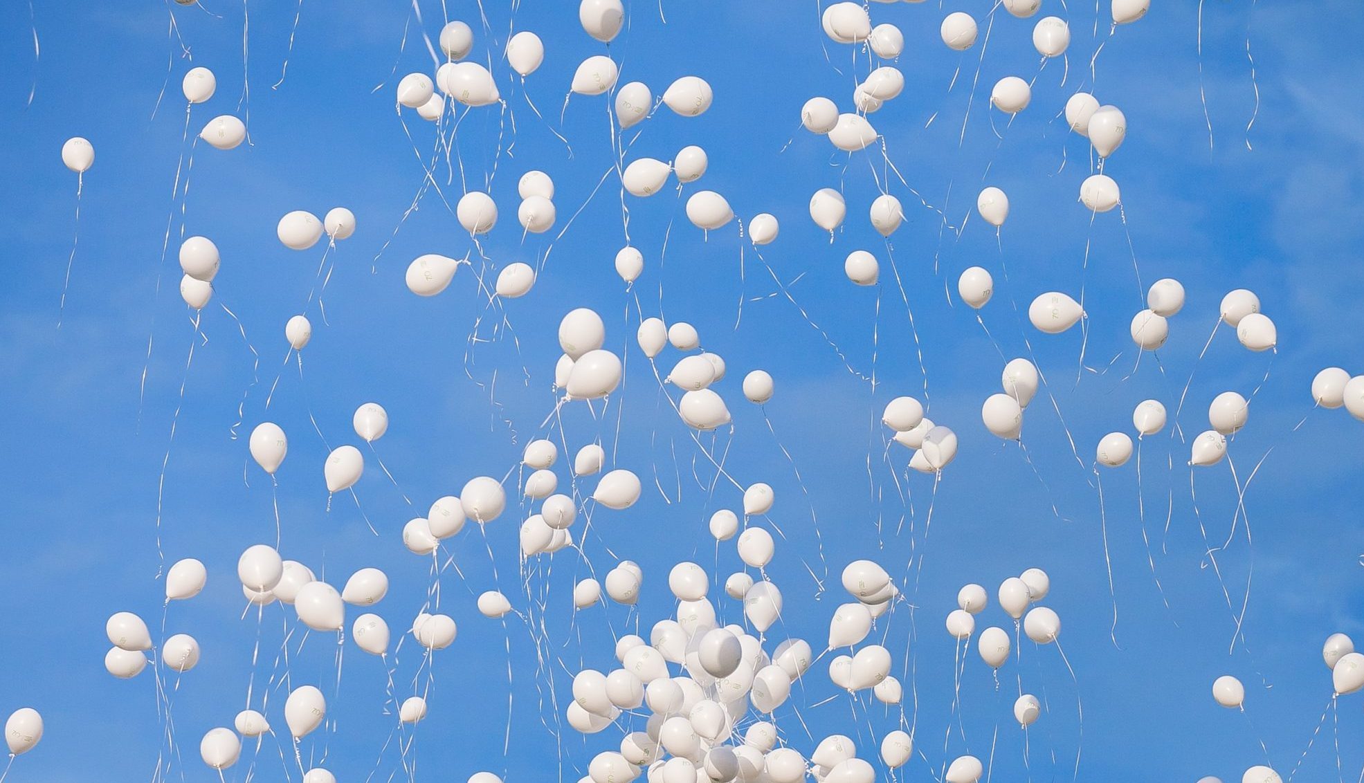 weiße Luftballons steigen in Himmel